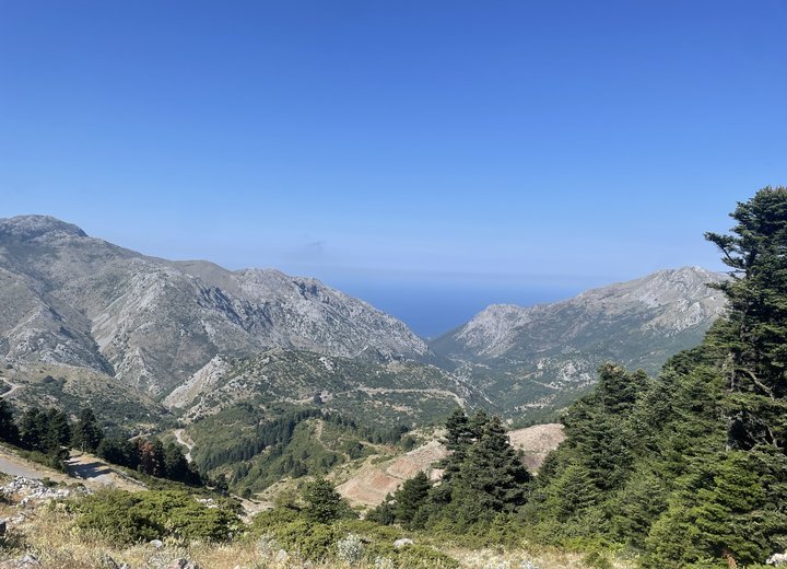 Mountain valley running down to the sea, on the road trip to an August beach camping trip